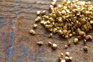 A mound of gold on an old wooden table